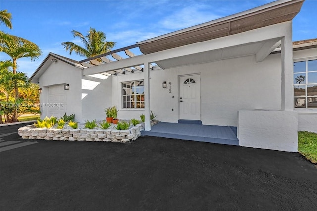 doorway to property with a garage