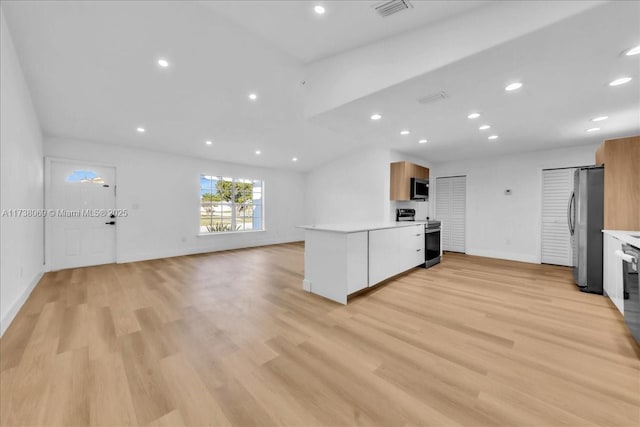 kitchen featuring white cabinetry, appliances with stainless steel finishes, and light hardwood / wood-style floors