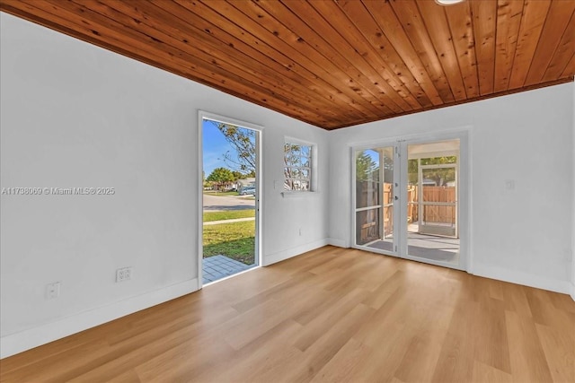 unfurnished room featuring wood ceiling, french doors, and light wood-type flooring