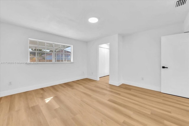 unfurnished room featuring light hardwood / wood-style floors