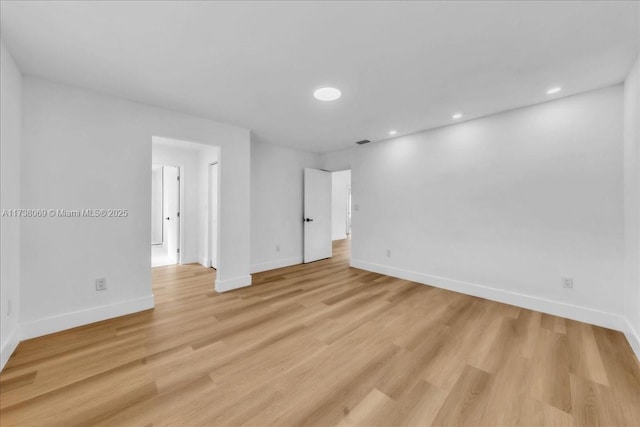 spare room featuring light wood-type flooring