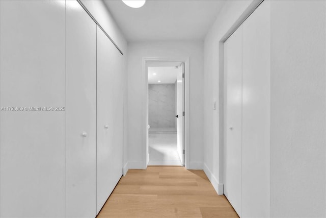 hall with light hardwood / wood-style floors