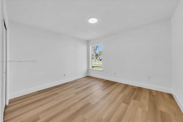 unfurnished room with light wood-type flooring