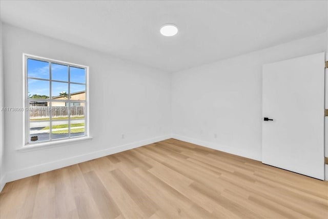 spare room featuring light hardwood / wood-style flooring