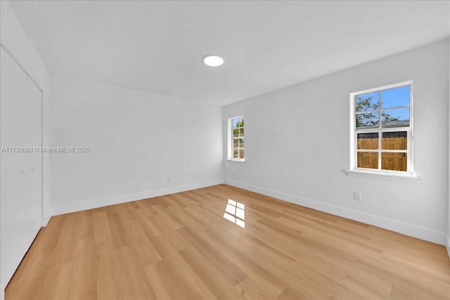 spare room with light hardwood / wood-style floors