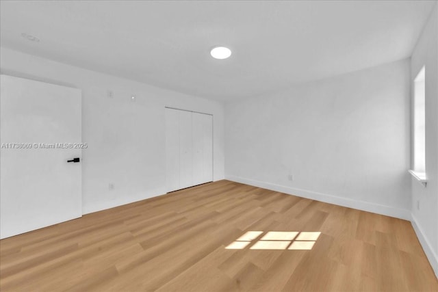 spare room with light hardwood / wood-style floors