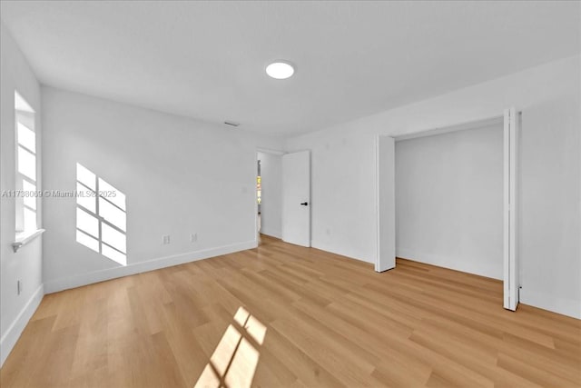 interior space featuring multiple windows and light hardwood / wood-style flooring