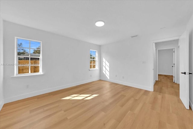 spare room featuring light hardwood / wood-style floors