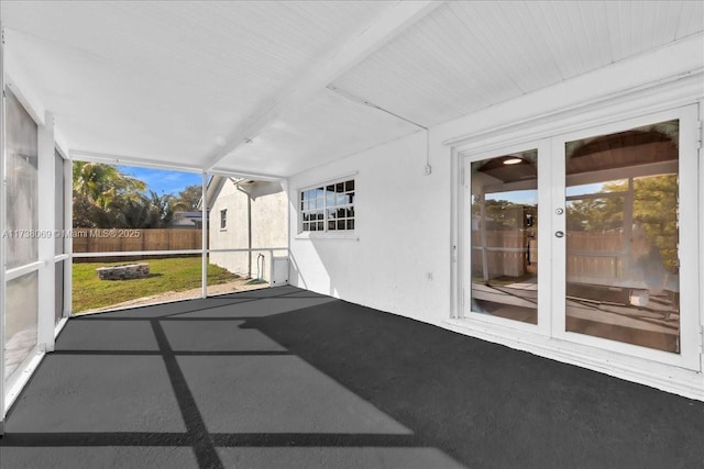 unfurnished sunroom featuring plenty of natural light and french doors