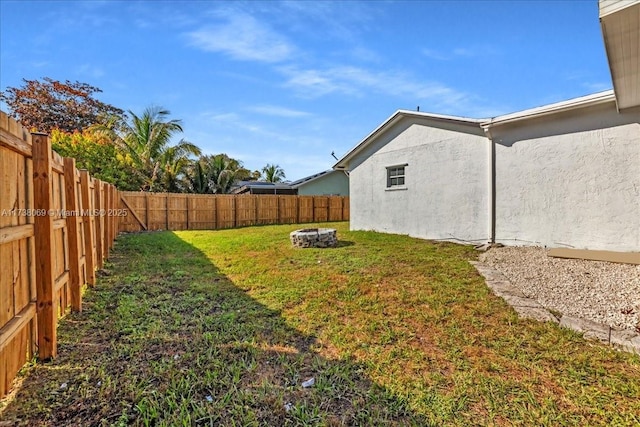 view of yard featuring an outdoor fire pit