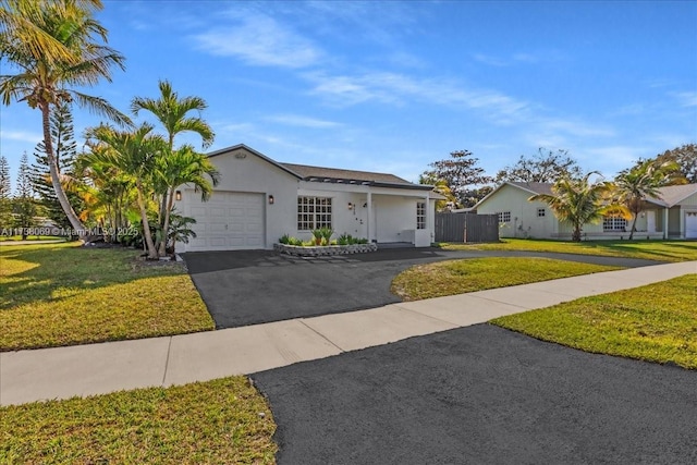 single story home featuring a garage and a front lawn