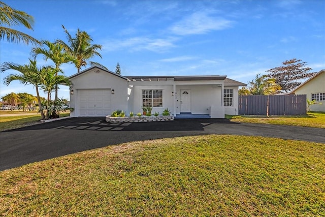 single story home featuring a garage and a front yard