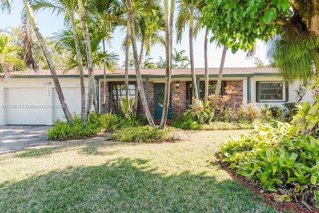 single story home featuring a garage and a front lawn