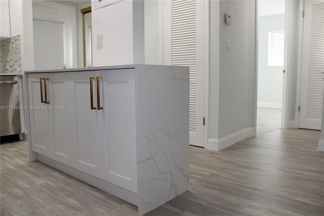 details with wood-type flooring and stainless steel dishwasher