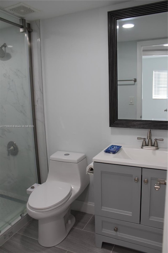 bathroom with vanity, walk in shower, and toilet