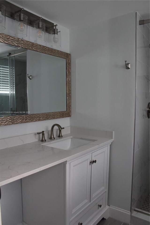 bathroom featuring vanity and tiled shower