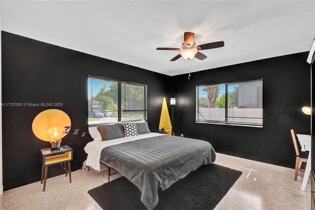 bedroom with ceiling fan and multiple windows