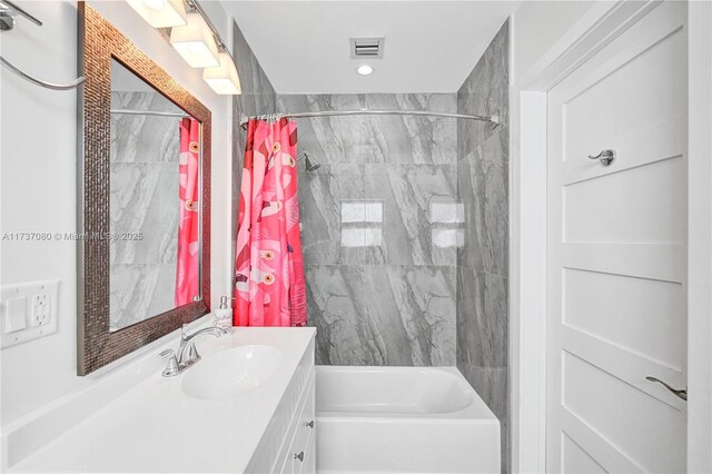 bathroom featuring vanity and shower / tub combo