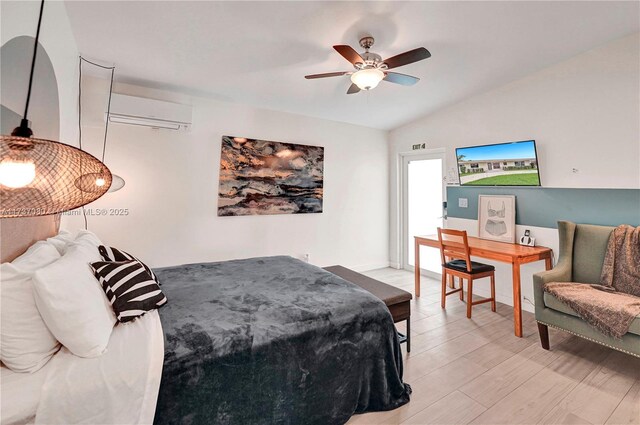 bedroom with vaulted ceiling, a wall mounted AC, ceiling fan, and light hardwood / wood-style flooring