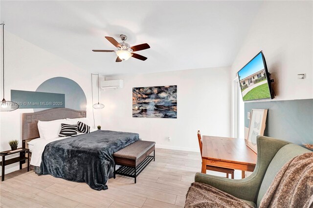 bedroom with ceiling fan, light hardwood / wood-style flooring, and a wall mounted AC