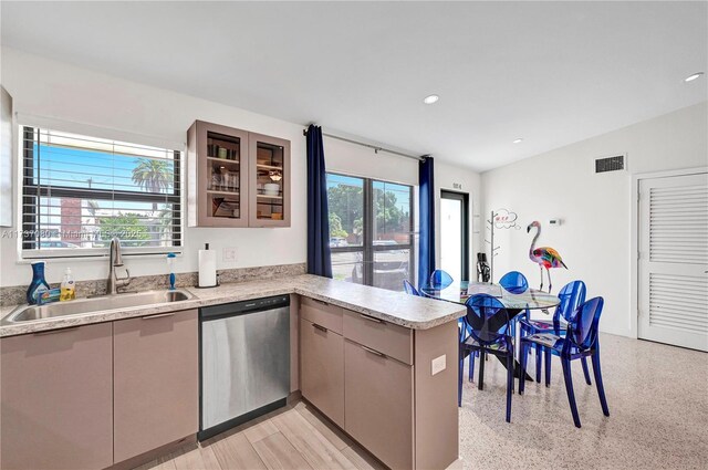 kitchen featuring light stone counters, appliances with stainless steel finishes, sink, and backsplash