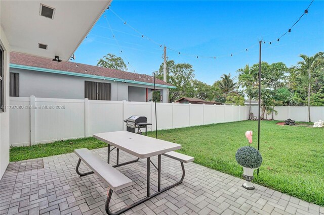 view of yard with central AC unit and a patio