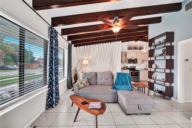 living room featuring ceiling fan, sink, and vaulted ceiling with beams