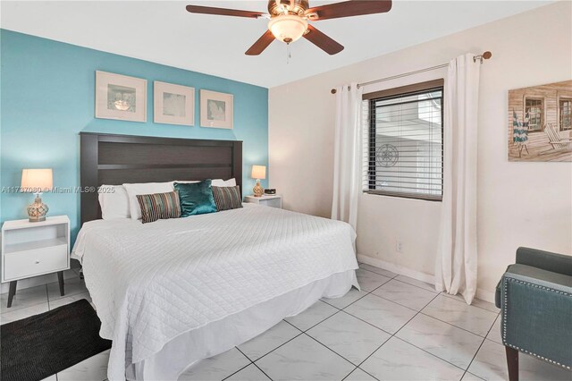 laundry area featuring light tile patterned floors and washing machine and clothes dryer