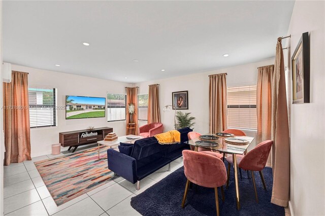 tiled living room with beam ceiling, sink, and ceiling fan with notable chandelier