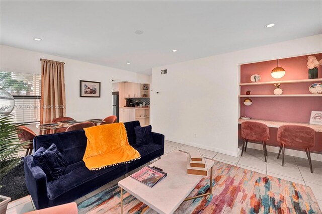 living room with beam ceiling, ceiling fan, and light tile patterned flooring