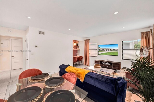 tiled living room with beamed ceiling and ceiling fan