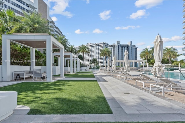 surrounding community featuring a yard, a swimming pool, and a patio