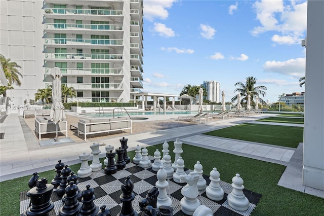 view of community featuring a swimming pool and a patio