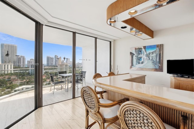 dining area featuring expansive windows and plenty of natural light