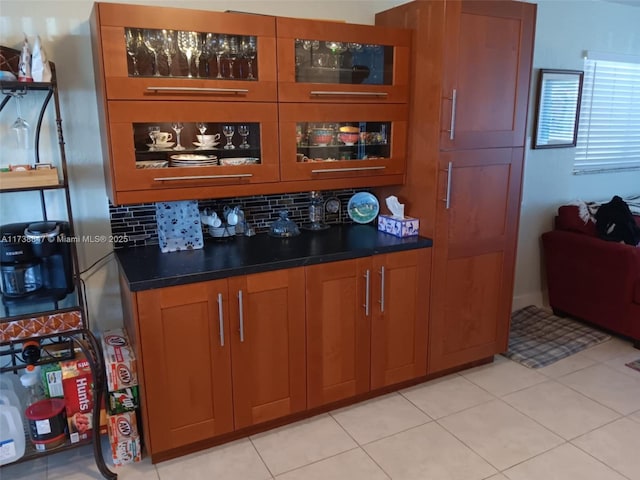 bar featuring tasteful backsplash and light tile patterned flooring