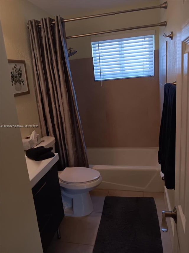 full bathroom featuring shower / bathtub combination with curtain, tile patterned floors, toilet, and vanity