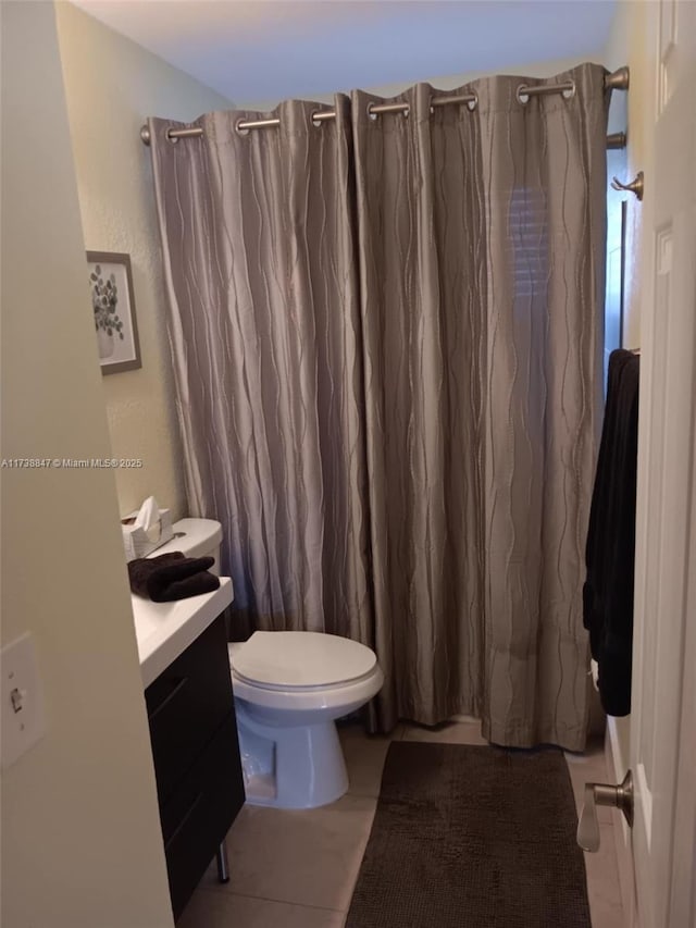 bathroom with walk in shower, vanity, toilet, and tile patterned flooring