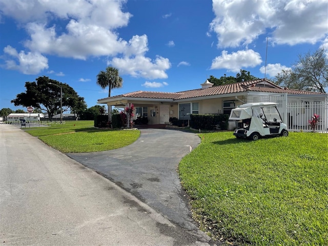 ranch-style home with a front lawn