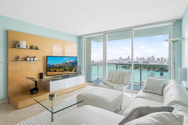 living room featuring light tile patterned flooring and expansive windows