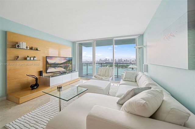 living room featuring a wall of windows and light tile patterned flooring