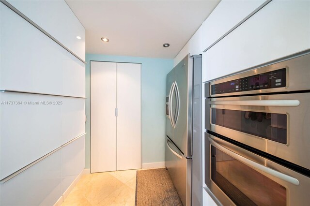 laundry room with stacked washer / dryer