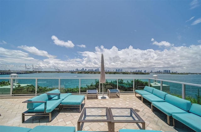 view of patio featuring an outdoor hangout area, a balcony, and a water view