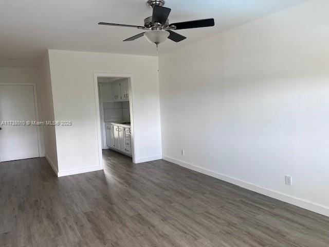 unfurnished room featuring ceiling fan and dark hardwood / wood-style flooring