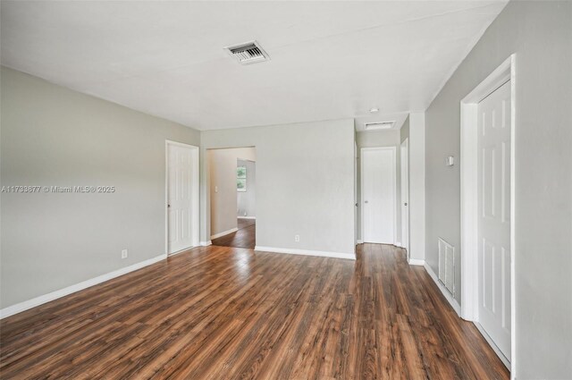 spare room with dark hardwood / wood-style floors