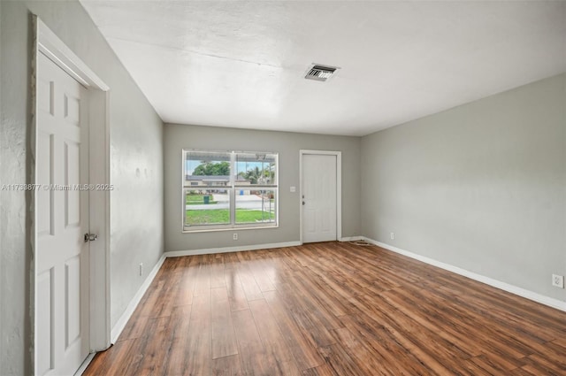 empty room featuring wood-type flooring