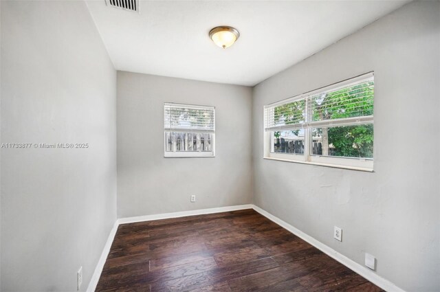 unfurnished room featuring dark wood-type flooring