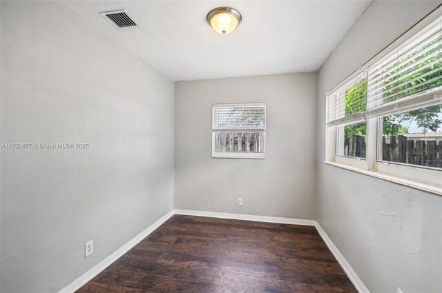 unfurnished room featuring dark hardwood / wood-style floors