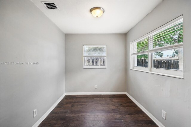 spare room with dark hardwood / wood-style floors