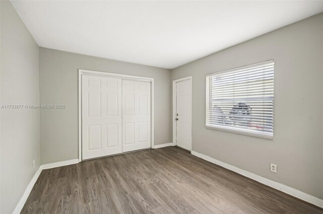 unfurnished bedroom featuring light hardwood / wood-style floors and a closet