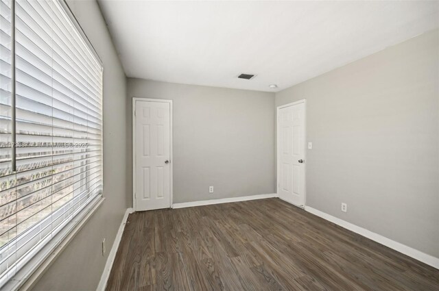 spare room featuring dark hardwood / wood-style floors